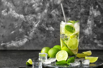 Glass of fresh mojito on dark background