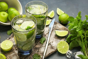Glasses of fresh mojito on table