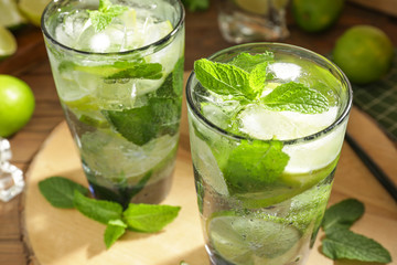 Glasses of fresh mojito on table, closeup