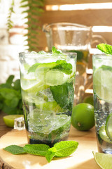 Glass of fresh mojito on table