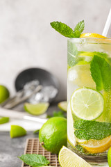 Glass of fresh mojito on grey table