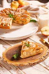 Slice of sweet apple pie on table