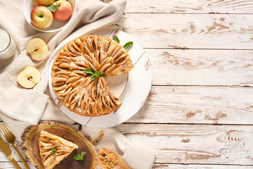 Composition with sweet apple pie on table