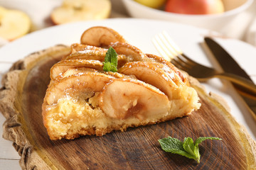 Slice of sweet apple pie on table, closeup