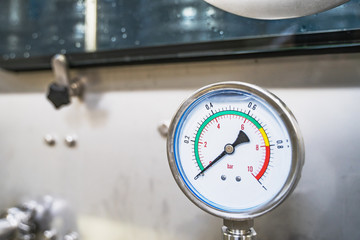 Manometer on industrial machine tool on factory, close up