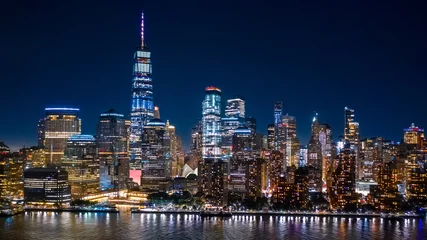Fotobehang Aerial view of Lower Manhattan skyline by in night in New York City © mandritoiu