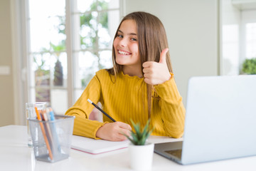 Beautiful young girl studying using computer laptop and writing on notebook happy with big smile...