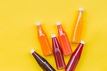 Juice Bottle Mock-Up, gradient juice bottles on yellow background. Variety of colorful Smoothies,...