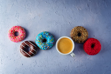 Colorful donuts with a Cup of coffee