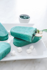 Plate with tasty spirulina ice-cream on table