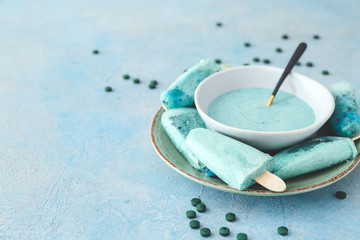 Plate with tasty spirulina ice-cream on table