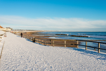 Promenade walk along Aberdeen city beach covered by snow, Scotland