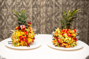 Fresh fruit salad served in bowls with fresh pineapple.