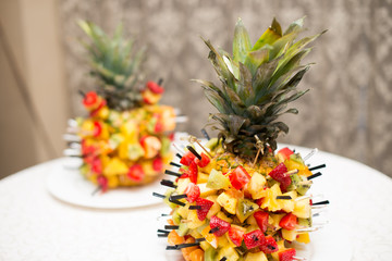 Fresh fruit salad served in bowls with fresh pineapple.