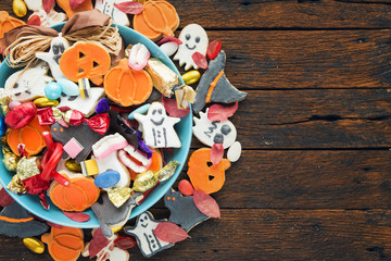 Halloween Jack o Lantern candy bowl with candy and halloween cookies Trick or Treat on old wooden background