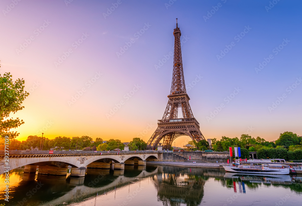 Wall mural view of eiffel tower and river seine at sunrise in paris, france. eiffel tower is one of the most ic