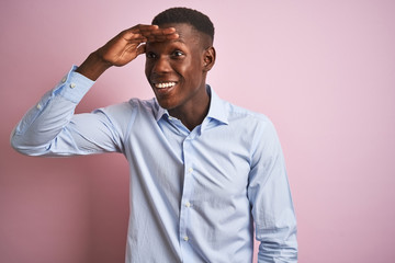African american man wearing blue elegant shirt standing over isolated pink background very happy...