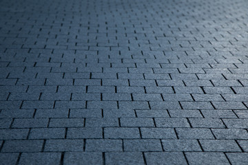 Dark grey granite rectangular pavement close-up texture background