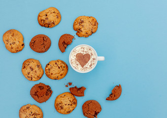 Cup of coffee with heart shape and cookies