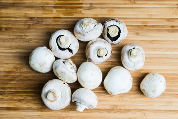 white mushrooms on wooden board