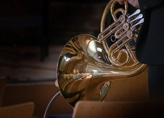 French horn, musical brass instrument made of tubing wrapped into a coil with a flared bell, before...