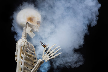 Skeleton vaping clouds of vapor with an ecigarette