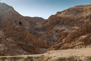 Fototapeta premium Caves in the Arid Sandy Windswept Hills Surrounding Qumran National Park, Israel