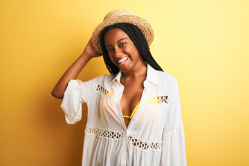 Beautiful african american girl wearing bikini and summer hat smiling happy