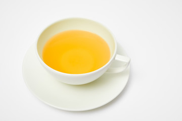 Herbal tea in a white cup isolated on white