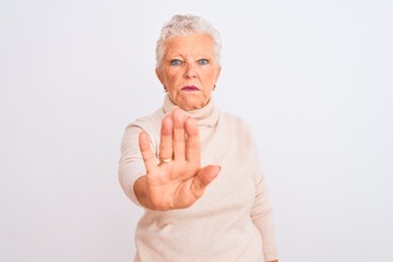 Senior grey-haired woman wearing turtleneck sweater standing over isolated white background doing...