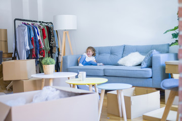 Beautiful toddler child girl jumping on the sofa
