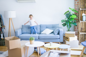 Beautiful toddler child girl jumping on the sofa