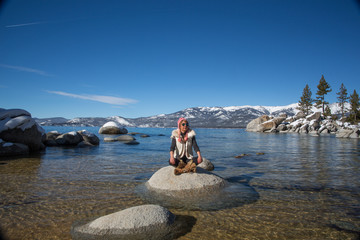 woman meditating on the beach