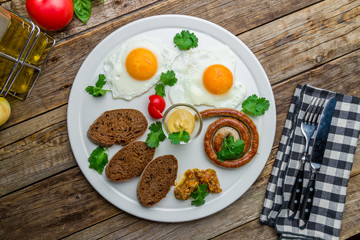 English Breakfast on a plate on wooden table