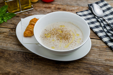 Cream soup of mushrooms on wooden table