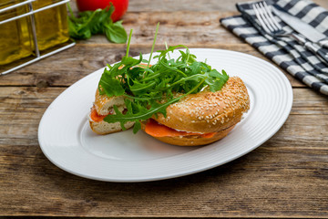 bagel with salmon on wooden table