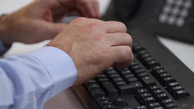 Professional man typing computer keyboard close up
