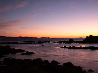 Fototapeta premium sunset from the beach with rocks