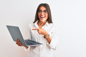 Beautiful businesswoman wearing glasses using laptop over isolated white background very happy pointing with hand and finger