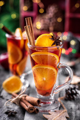 Two glass of Christmas mulled wine with cinnamon stick and star anise, vertical composition
