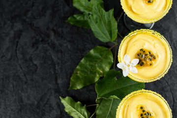 Passion fruit mousse on dark background, top view