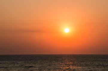 Fototapeta na wymiar Dawn on the beach, orange-red gradient in the sky, sun, golden hour. Sunrise, sunset. Copy space.