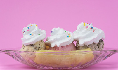 Whip cream on Banana Split in glass on pink background, Food concept, Blank for design..