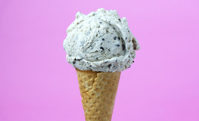 Strawberry ice cream scoop in cone on pink background, Closeup Front view Food concept..