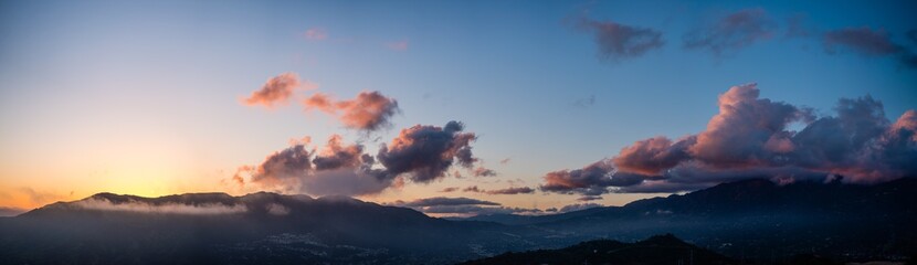 Moody cloudy sunset panorama over los angeles mountains