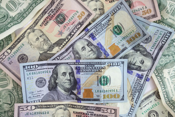 United States currency background with hundreds and fifties.