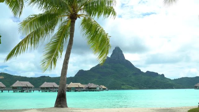 Bora Bora Tropical vacation paradise island with overwater bungalows resort hotel in coral reef lagoon ocean and beach. Mount Otemanu, Bora Bora, French Polynesia, Tahiti, South Pacific Ocean.