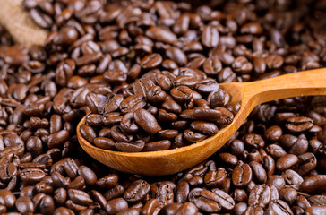 Wooden spoon of coffee beans and bag.