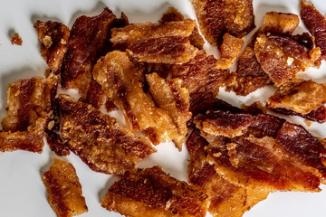 crumbled crispy bacon on a white plate