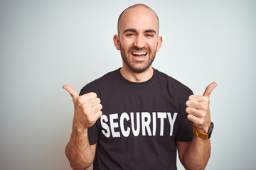 Young safeguard man wearing security uniform over isolated background success sign doing positive...